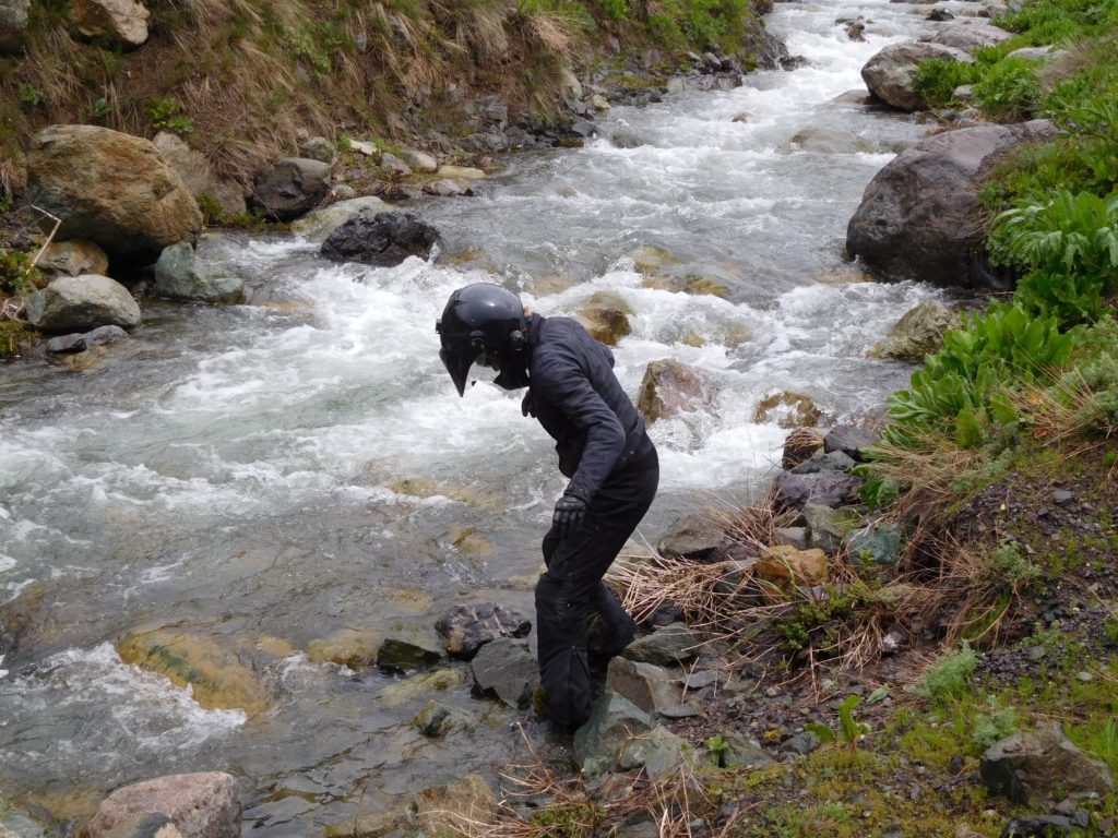 Me washing all the mud off my boots in a stream